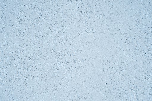 roughcast plaster wall background texture in light blue